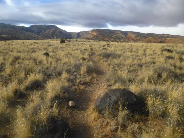 Black boulders on Johnson Mesa, with Fremont Gorge and Miners Mountain ahead, Fremont River Gorge Overlook Trail, Capitol Reef National Park