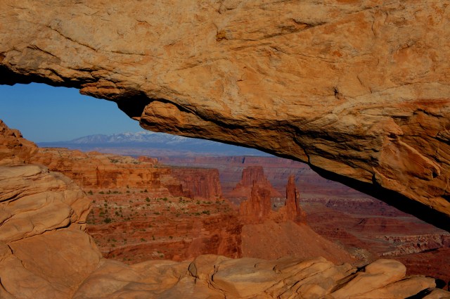 View through Mesa Arch to Monster Tower, Washer Woman Arch, and Airport Tower